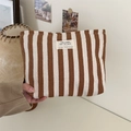 Detail of hand-held canvas toiletry bag with brown stripes and a woven fabric label - Brown