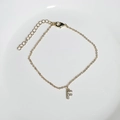Delicate 18K gold plated bracelet featuring a sparkling zircon initial F charm pendant - Letter F
