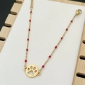 Bohemian paw pendant bracelet with gold chain and vibrant red beads in a close-up view - Red