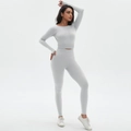 Close-up of seamless ruched yoga set featuring grey long-sleeve crop top and leggings - S / Moonlight White