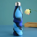 Close-up of unfolded blue camouflage silicone collapsible water bottle with a metal carabiner - Camo Blue