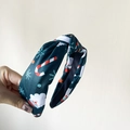 Dark green Christmas headband with Santa and candy cane prints in a knotted style - Printed Green