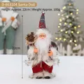 Standing Santa Claus doll in red plaid hat holding burlap sack with natural pine cones - Red and Grey Plaid Style