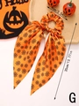 Detail view of orange Halloween hair scrunchie with spider web print and long ribbons - Style G