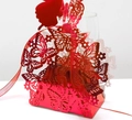 Detail of red laser-cut butterfly candy box with pearlescent paper and matching silk ribbon - Reflective Bright Red