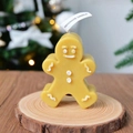 Handmade gingerbread man shaped scented candle on a rustic wood base with holiday lights - Mixed Color Gingerbread Man