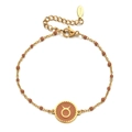 Detailed macro shot of gold stainless steel Taurus zodiac bracelet with reddish brown beads - Stainless Steel / Taurus-Reddish Brown