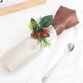Christmas napkin ring with pine needles, red berries, and pinecone on a white cloth - Plastic Pine Cone Pine Needle Napkin Ring
