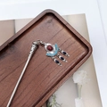 Detailed view of a vintage silver hair stick with colorful gems and tassels on wood - F0742 Hair Stick-27# (Ethnic Multi-Gemstone Tassel)