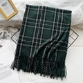 Plaid checkered scarf in green and dark tones with tassel fringe on a metal basket - Official Green