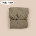 Detail of baby fitted sheet with elastic band and natural wrinkled cotton gauze texture - Dark Khaki / 81*41 cm