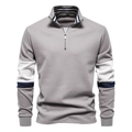 Detail of grey half-zip sweatshirt featuring navy and white striped collar and sleeve accents - Gray