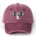 Close-up of vintage washed cotton baseball cap featuring a dumbbell graphic print - Burgundy