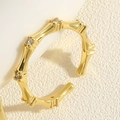 Macro detail of 14K gold plated bamboo ring featuring sparkling zircon stones - Bamboo Zirconia Design