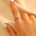 Detail of silver sunburst star ring with cubic zirconia worn on finger with silk background - Steel Silver (8500)