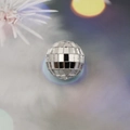 Detail of a silver mosaic glass disco ball ornament showing reflective mirror tiles - 3cm Sphere