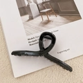 Glossy black large shark hair claw clip displayed on a minimalist fashion magazine - 11cm / Bright Black