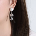 Baroque style pearl drop earrings with layered silver flower petals on a female model - Steel Color Earrings (F975)