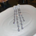 Dettaglio degli orecchini a nappa color argento con cristalli su piatto in ceramica - Argento Zirconia Forma U Nappa