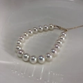 Close-up of aurora pearl bracelet with 14k gold-filled clasp and iridescent white pearls - 14K Gold Filled-Aurora Tennyo White (10mm)