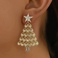 Close-up of golden Christmas tree earrings with rhinestones worn by a model - Gold White Zirconia Tree