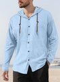 Detail of light blue cotton hoodie shirt with drawstring hood and brown buttons on beach - Light Blue