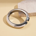 Detailed view of polished silver metal bangle with a hinged clasp on stone background - Open Bangle - Silver