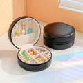 Portable round black PU leather jewelry box organizer with secure zipper closure - Elegant Black