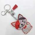Sparkling cat rhinestone keychain featuring red crystal studs and decorative red tassel - Red