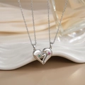 Macro shot of silver heart pendant necklaces with micro-set green and pink zircon stones - Silver Colorful Stone Heart Puzzle XL0288