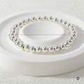 Detailed view of 6mm silver beaded stretch bracelet with 24g weight and 16-17cm length - 6mm / Silver