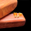 Macro view of gold-plated mini stud earrings with sparkling round cubic zirconia stones - 3mm Stud Style (Single) / Gold