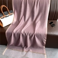 Detail of pink transparent scarf with gold trim draped elegantly on a leather sofa - Leather Purple
