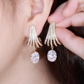 Elegant gold drop earrings with white zircon in a fanned design worn by a model - Golden White