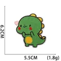 Detail of green dinosaur embroidered patch showing 6.2cm height and 5.5cm width dimensions - No. 4 (Green Spiky Dinosaur)