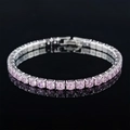 Macro shot of silver tennis bracelet featuring round pink zircons and a secure fold-over clasp - 4mm-17cm / Pink Zirconia