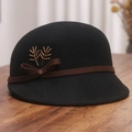 Detailed view of black wool felt hat featuring brown bow ribbon and golden branch ornament - M (56-58cm) / Black