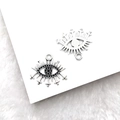 Macro shot of silver Eye of Horus pendants with black gemstone and cross details - Eye (19x22mm)