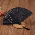 Detail of a black bamboo folding fan with ink bamboo painting and a black silk tassel - Ink Bamboo