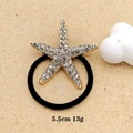 Close-up of golden starfish hair tie with rhinestones on beige background, 5.5cm size - Golden Large Starfish