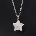 Close-up of translucent star-shaped natural crystal pendant on a delicate silver chain - White Crystal