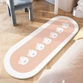 Oval pink and white plush nursery rug featuring cute cartoon bear patterns on wood floor - Round Bunny