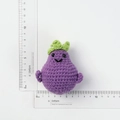 Handmade knitted purple eggplant keychain with a cute smiling face and green leaves - Smiley Purple Eggplant