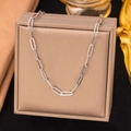 Silver paperclip chain necklace for women displayed on a beige jewelry gift box - Cross Chain Necklace / Steel