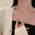 Elegant gold heart pendant necklace on model showcasing the delicate collarbone chain - Heart Pendant Necklace