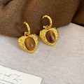 Macro detail of heart-shaped gold earring with tiger eye stone and crystal accent - Heart Shape Hammered Metal Inlaid Brown Cat's Eye Style (27#)