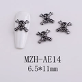 Detail view of 6.5x11mm gun-black metal skull nail charm on a white base plate - Skull Style 2 (AE14)