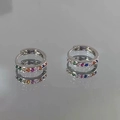 Detail shot of silver rainbow hoop earrings with colorful cubic zirconia stone inlays - Contrast Color Zirconia Ear Buckle