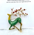 Christmas reindeer brooch badge with green enamel body and golden antlers on white card - Classic Red Green Reindeer