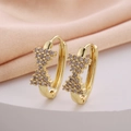 Elegant gold bow earrings with cubic zirconia stones on white display stand - Pave Zirconia Bow